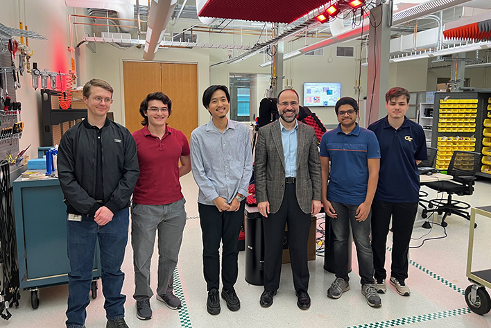 Nader Behdad and a group of Georgia Tech students and researchers shown posing in a laboratory